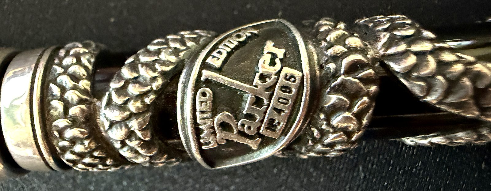 Close-up of the silver band on the Parker Snake, stamped LIMITED EDITION, Parker, and the serial number 4095.