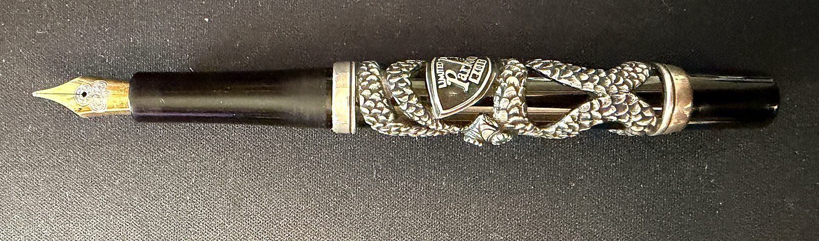 The Parker Snake uncapped, showing the gold nib at one end and the silver snake wrapped around the barrel with the Limited Edition shield.