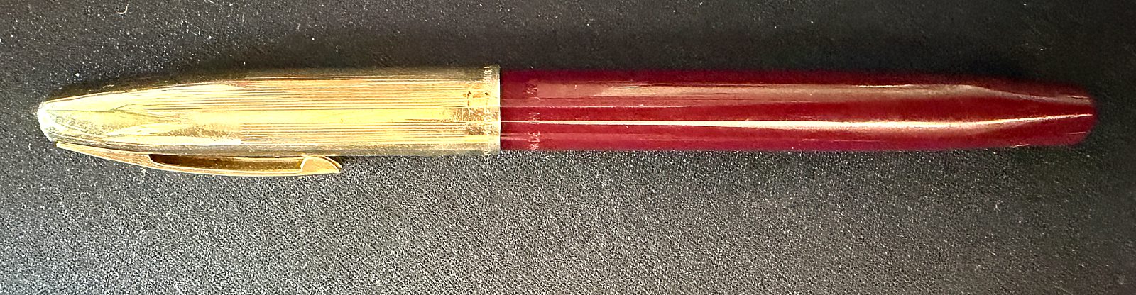 The Sheaffer Imperial VIII fountain pen, capped, showing a gold filled cap with a slim clip and a burgundy barrel.